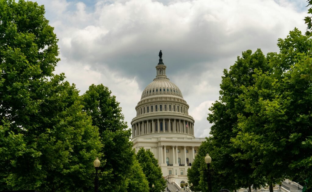 The dome of the United States Capitol building against a blue sky.