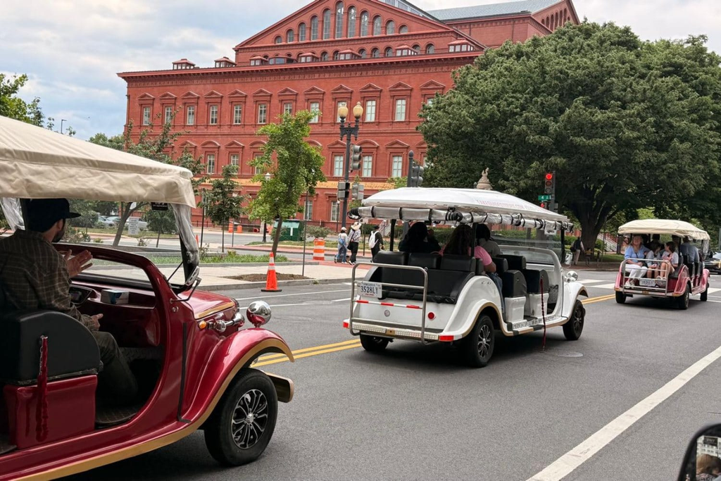 Open-air E-Cart tour near the monuments on the National Mall in Washington DC Caption: A guided tour covers more of the National Mall without the walking.